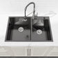 Black double-bowl kitchen sink with two compartments and two round drain openings