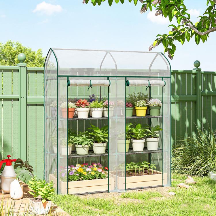 Clear mini greenhouse with green frame, arched roof, and transparent walls