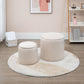 Two cream white round ottoman stools on a rug, with removable padded lids