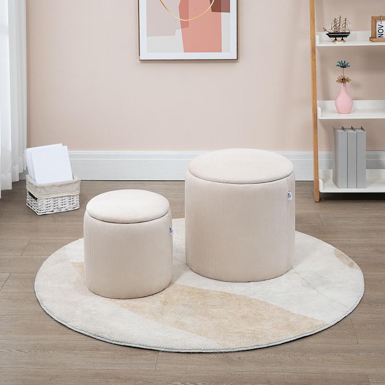 Two cream white round ottoman stools on a rug, with removable padded lids