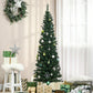 Artificial pencil Christmas tree with green needles and visible ornaments including white baubles
