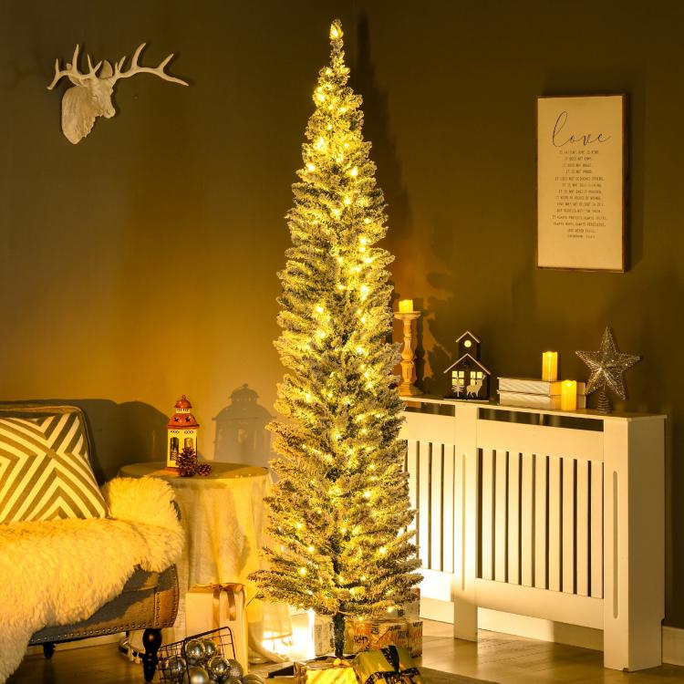 Narrow artificial pencil Christmas tree densely covered in warm white lights