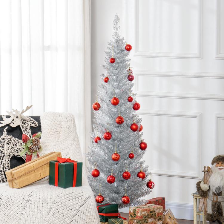 Silver unlit pencil artificial Christmas tree decorated with red baubles and gifts at base