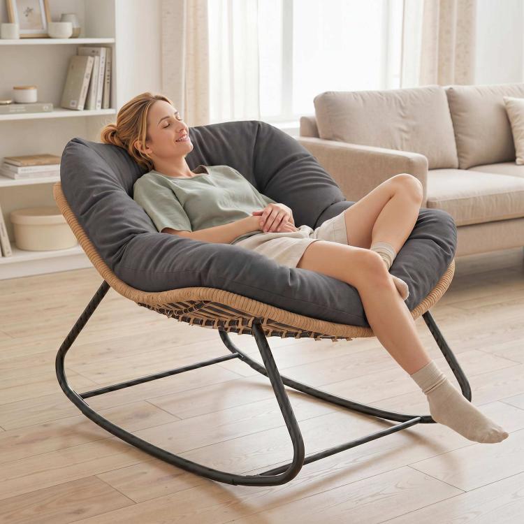 Oversized dark gray rocking egg chair with cushion, woven base and black metal frame