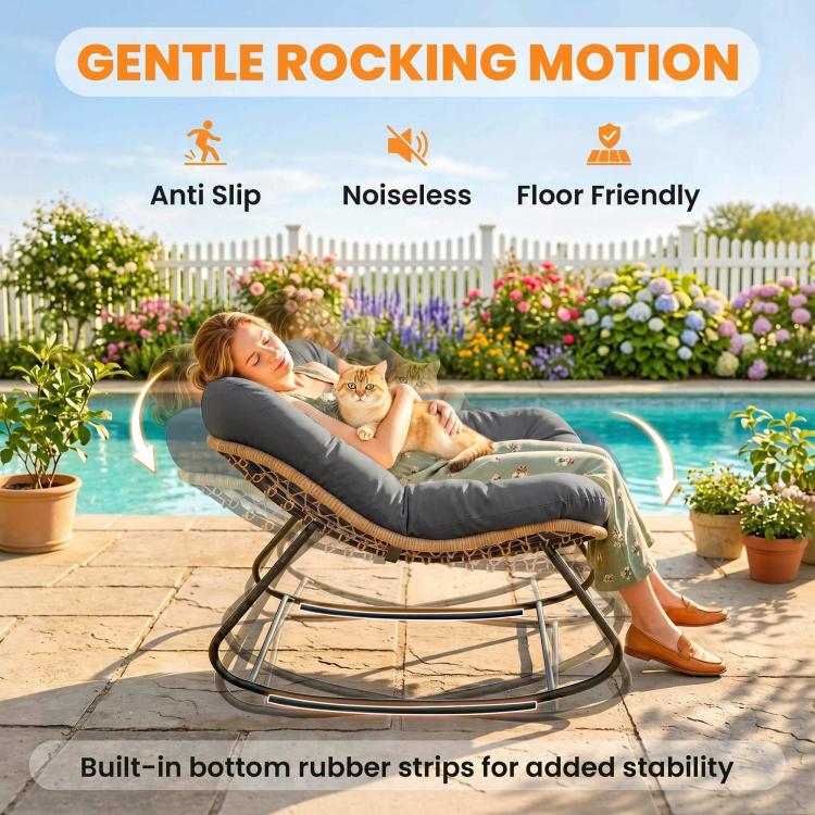 Dark gray rocking egg chair with cushioned seat and woven wicker base on black steel rockers