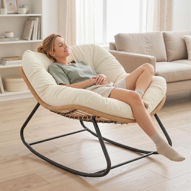 Oversized rocking egg chair with light beige cushion and woven base