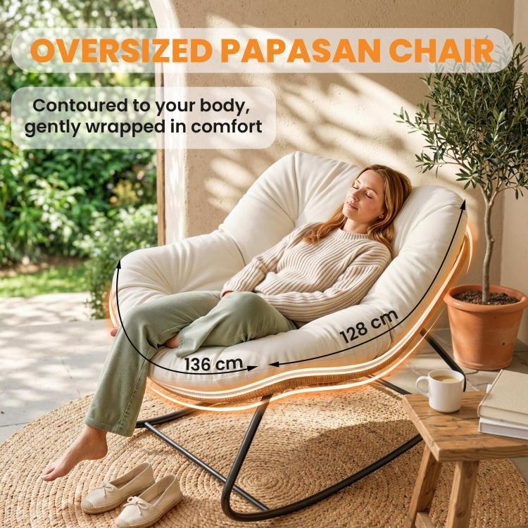 Oversized cream rocking chair with thick cushion, black frame, and woven rattan sides
