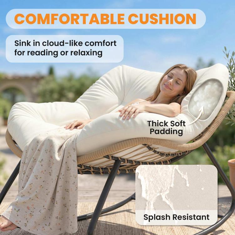 Cream padded papasan rocking chair with thick cushion and woven base on outdoor patio