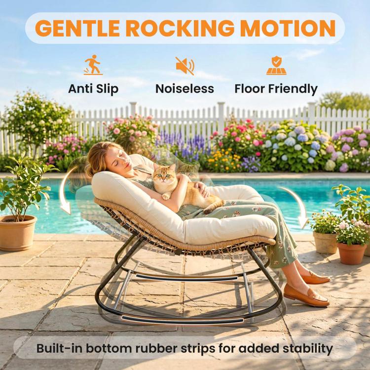 Cream cushioned rocking egg chair with woven rattan seat and black metal base by garden