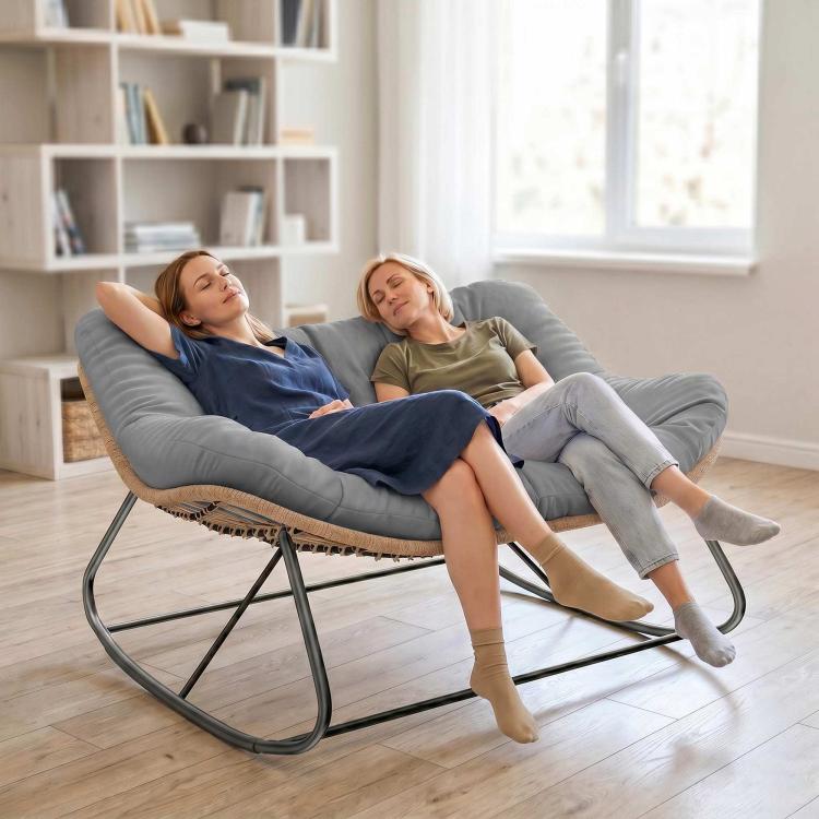 Gray upholstered rocking egg chair with tufted cushion and dark metal base