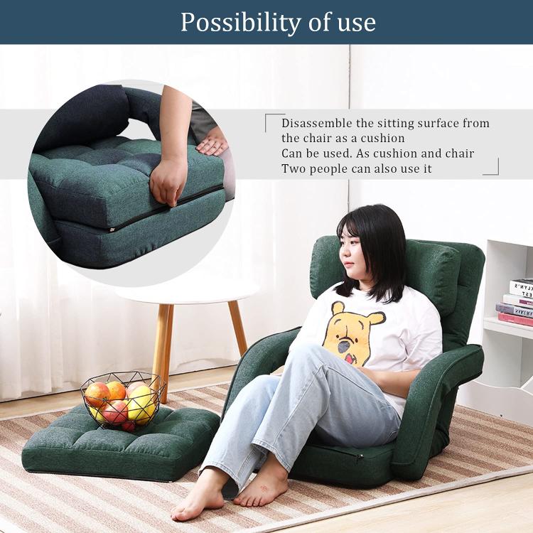 Green folding floor chair with removable seat cushion and padded backrest, armrests
