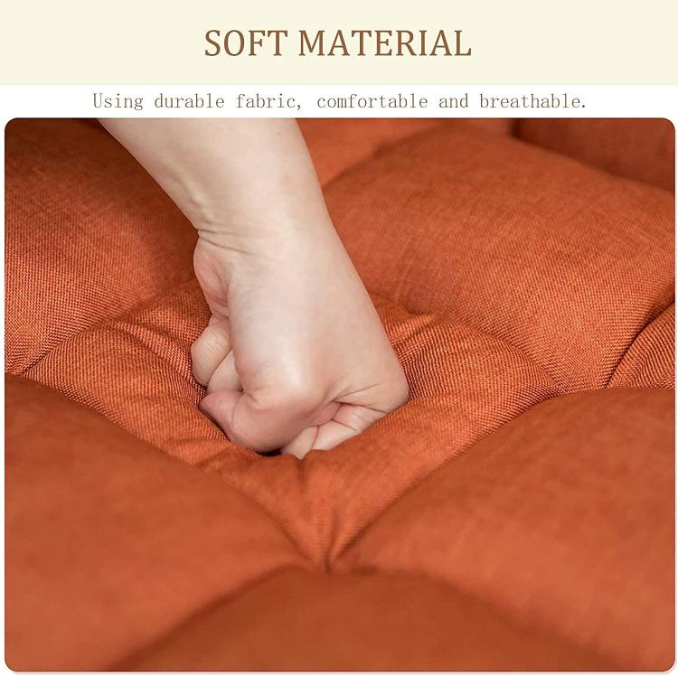 Orange upholstered seat cushion fabric with stitched seams, hands adjusting the padding
