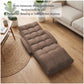 Brown cushioned floor chair reclined for lounging with contoured back support