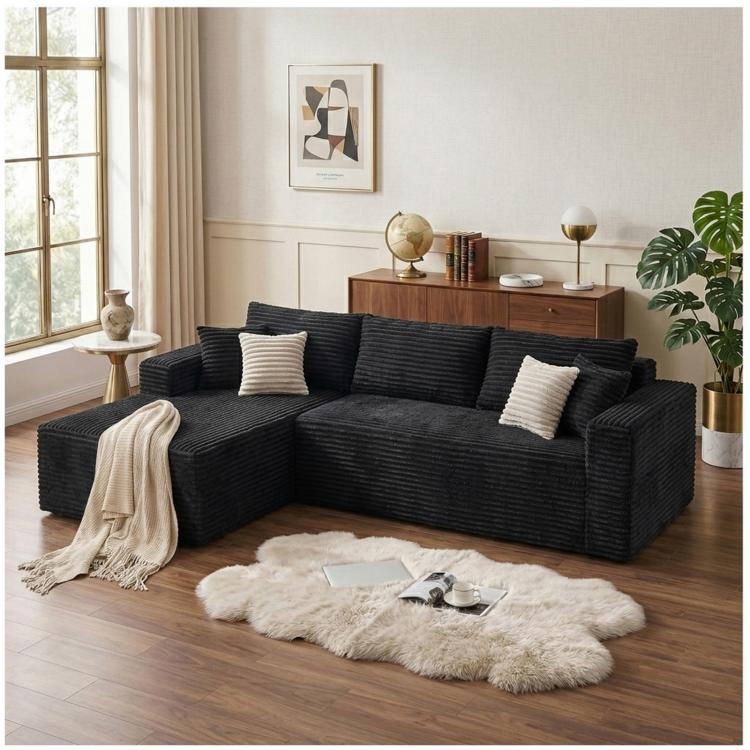 Black corduroy sectional sofa with L-shape, oversized chaise, and throw pillows