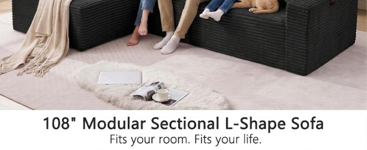 Black corduroy modular L-shaped sectional sofa with oversized chaise