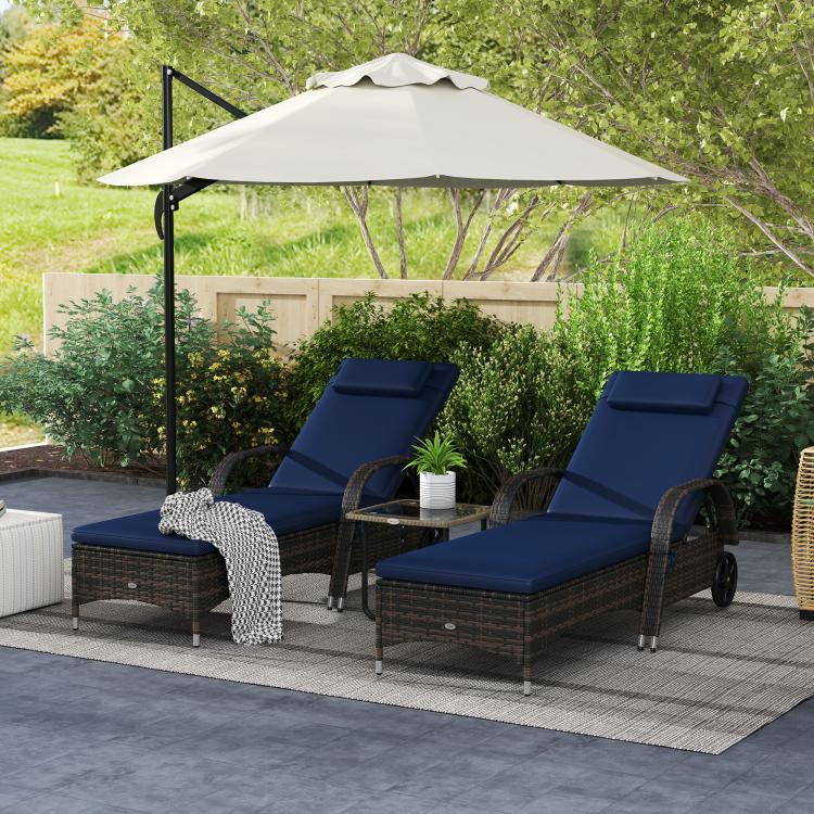 Outdoor set of 2 reclining chaise lounge chairs with blue seat cushions and dark woven bases