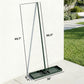 Green lawn leveling rake with handle and ridged base on a patio, size view