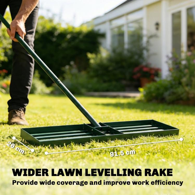 Green lawn leveling rake on grass, with push handle and ridged leveling frame