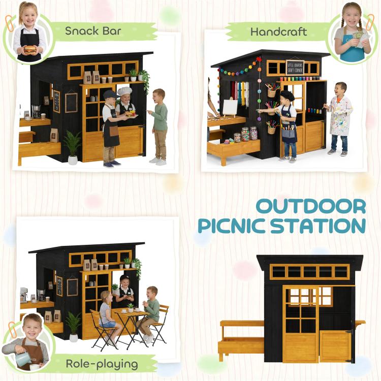 Black wooden playhouse with attached outdoor picnic station table and side benches