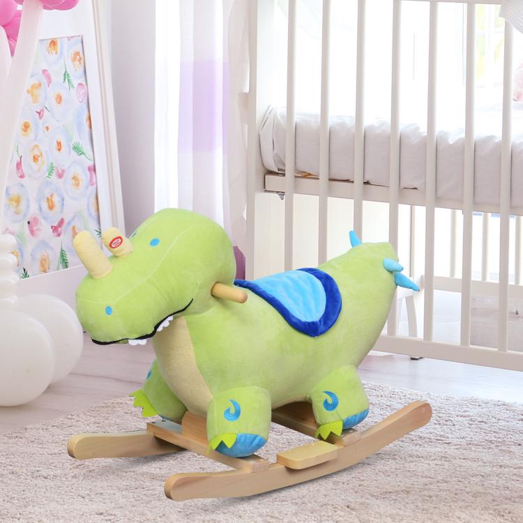 Green plush dinosaur rocking horse toy with blue saddle and wooden runners for kids