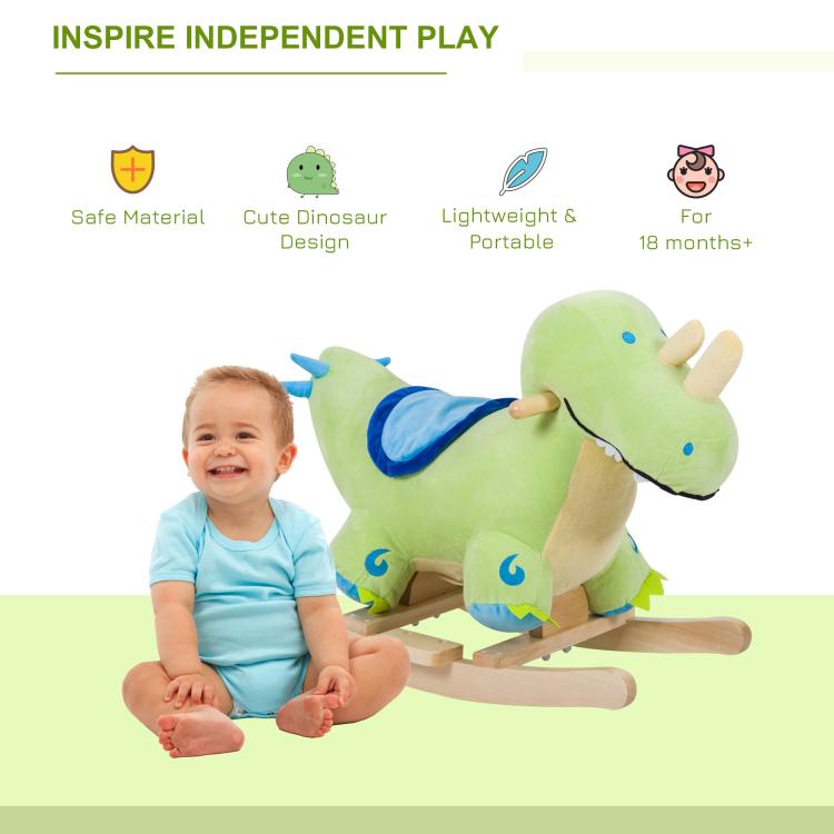 Kids using green plush dinosaur rocking horse with blue saddle and wooden base