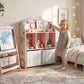 Pink kids bookshelf with toy storage drawers, open shelves, and book display top