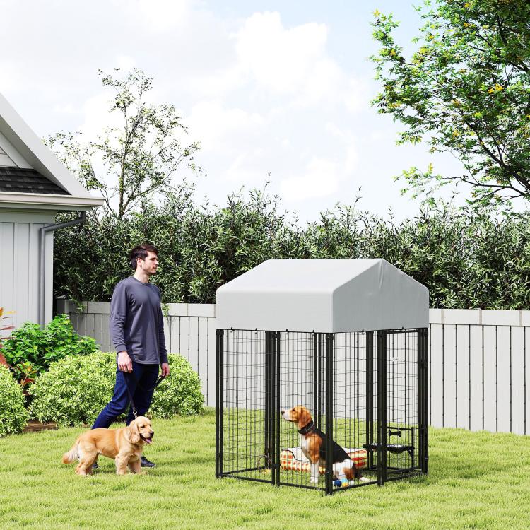 Outdoor dog kennel with white roof and black welded wire fence, yard playpen enclosure