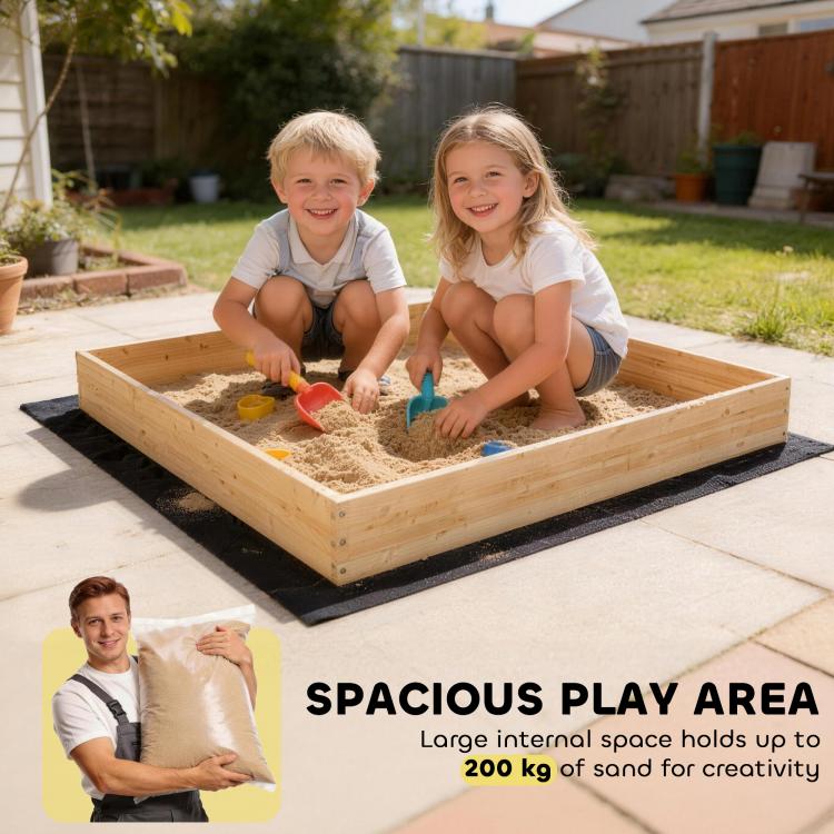 Wooden kids sandbox with dark liner, digger tool, and two children playing in sand