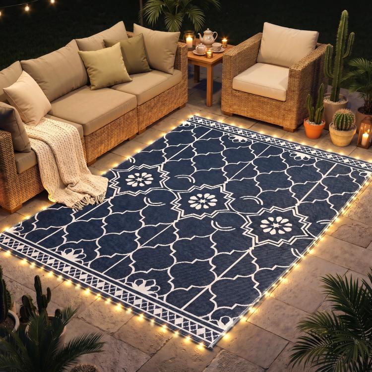 Outdoor rug on patio with warm LED strip border lighting and white geometric medallion pattern