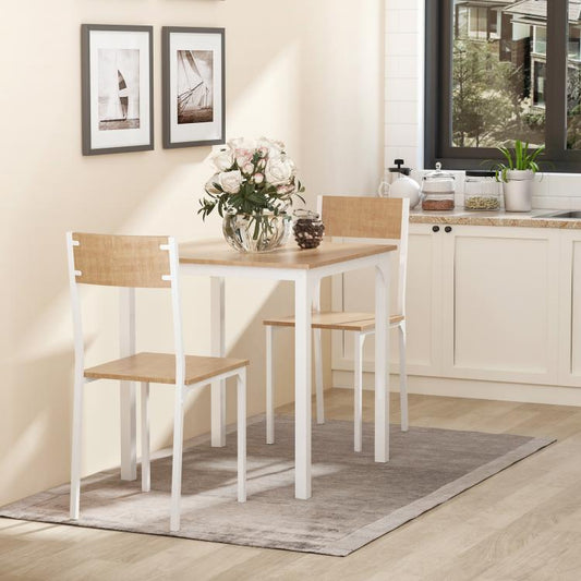White dining table set with square tabletop and two wood-tone chairs in a room.