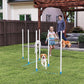 Dog agility weave pole set in yard with white poles and blue bases during training