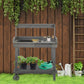 Gray wooden potting bench with open shelves and top sink