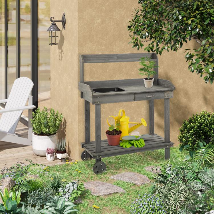 Gray potting bench with sink top and lower shelf for gardening tools