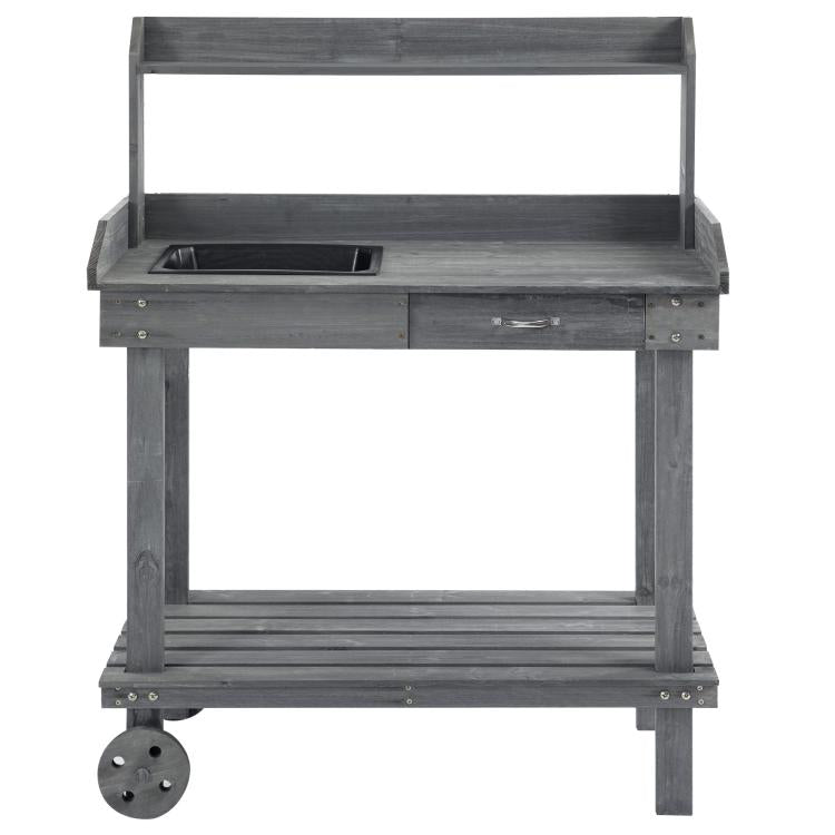 Gray wooden potting bench with sink recess, drawer front, and bottom shelf