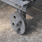 Close-up of gray potting bench wheel with axle mount