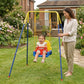 Toddlers’ blue-and-yellow swing set with red seat and hanging ropes in an outdoor yard