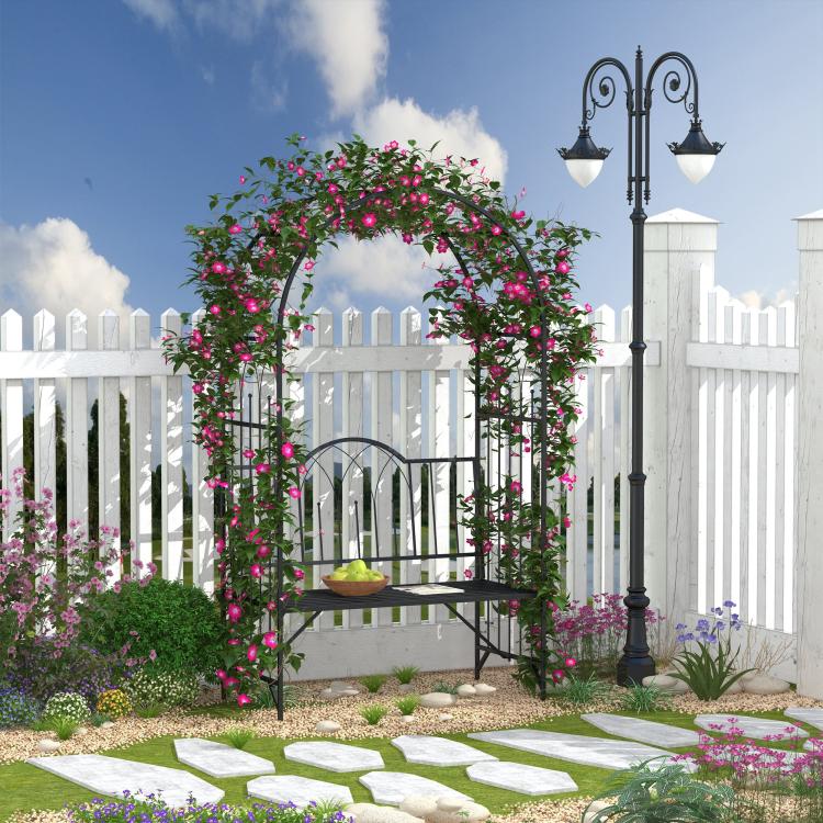 Black metal climbing arbor bench with arched trellis, decorated with pink flowering vines