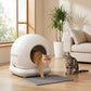 White enclosed cat litter box with round doorway and gray litter mat, two cats
