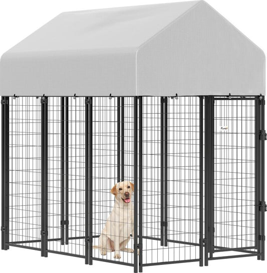 Outdoor dog kennel with peaked roof, gray cover, black welded wire walls, front door.
