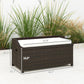 Outdoor wicker storage bench, dark brown woven frame with light cream cushion on top