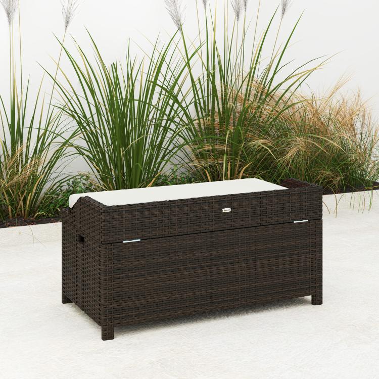 Outdoor wicker storage bench angled view, dark brown woven frame with light cream cushion
