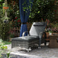 Outdoor chaise lounge chair with gray cushion and headrest on a woven rattan frame