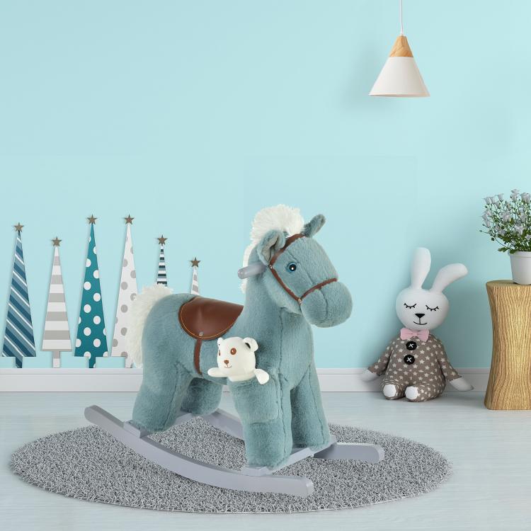 Blue plush rocking horse with bear plush and gray rocking base on floor