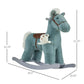 Blue plush rocking horse with brown saddle and bear plush, side profile