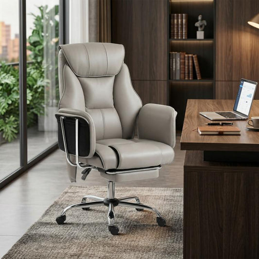 Gray high-back massage office chair with PU leather look, footrest, and caster base