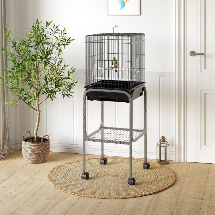 Black bird cage on wheeled stand with wire floor and curved top bars