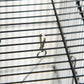 Close-up of black bird cage bar with perch bracket and hanging hook