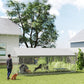 Outdoor chain-link dog kennel with waterproof roof; dogs inside in backyard