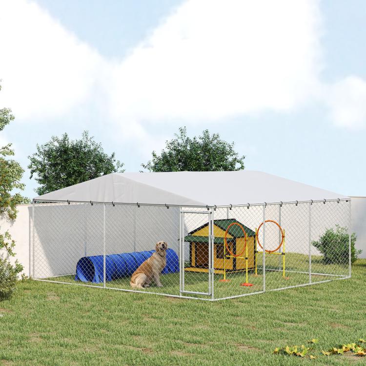 Outdoor dog kennel with silver frame and gray waterproof roof, chain-link sides, large area with toys