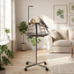 Dark gray bird play stand with round tray, ladder steps, stainless bowls, and rolling wheels